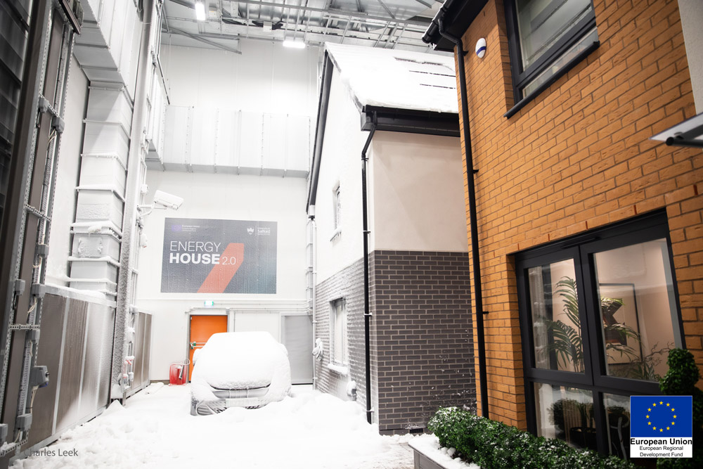 Two detached houses built within chamber 1, with snow, of Energy House 2.0, University of Salford