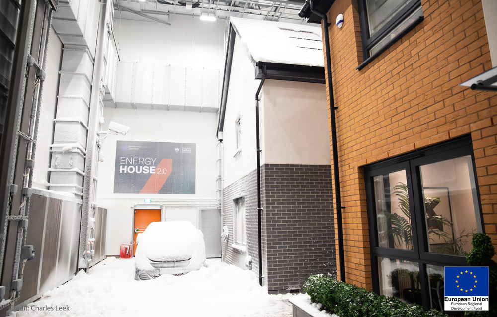 Two detached houses built within chamber 1, with snow, of Energy House 2.0, University of Salford